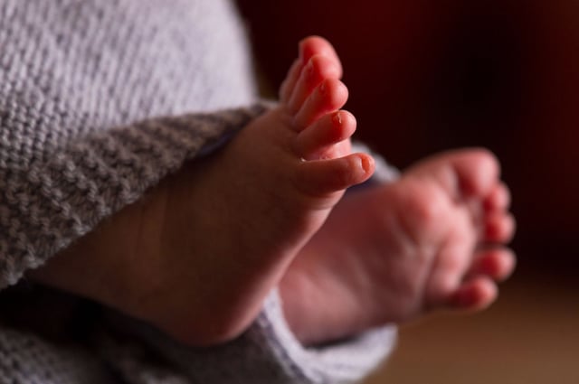 Born babies stats. File photo dated 23/01/16 of the feet of a new baby wrapped in a blanket.