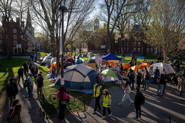 Students protest the war in Gaza and passersby walk in Harvard Yard on April 25, 2024, in Cambridge, Massachusetts.