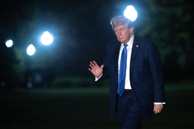 US President Donald Trump waves as he walks from Marine One after arriving on the South Lawn of the White House in Washington, DC, on April 24, 2025.