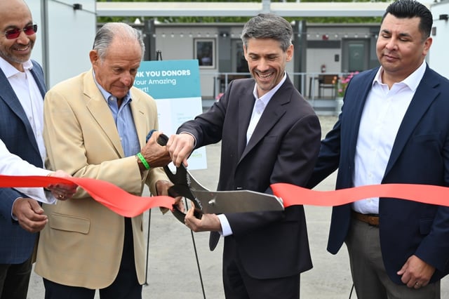 Philanthropist John Sobrato and San Jose Mayor Matt Mahan, center, perform the ceremonial ribbon cutting at the city’s newest 135-unit interim housing community at 6370 San Ignacio Ave. on April 24, 2025. (Devan Patel/Bay Area News Group)
