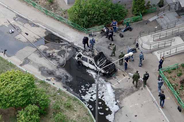 Officers work at the site of the car bomb that which killed the Russian general in Balashikha, outside Moscow, on April 25.