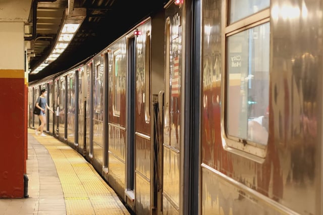 A woman boards the train at the City Hall subway station in Manhattan on May 30, 2022.
