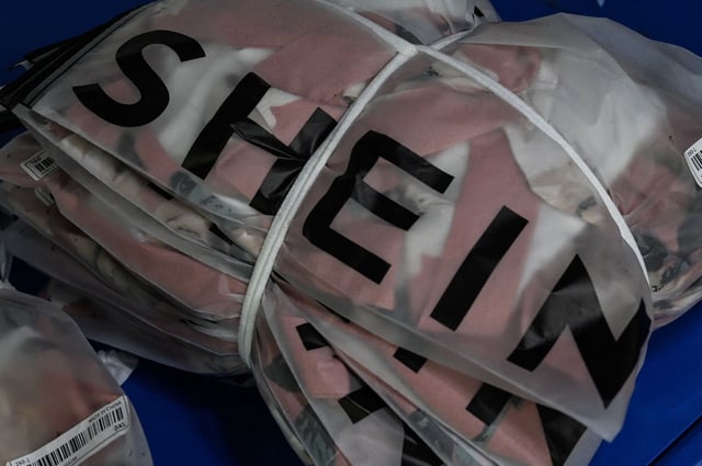This picture shows signage of cross-border fast fashion e-commerce company SHEIN at a garment factory in Guangzhou, in China's southern Guangdong province on July 18, 2022.