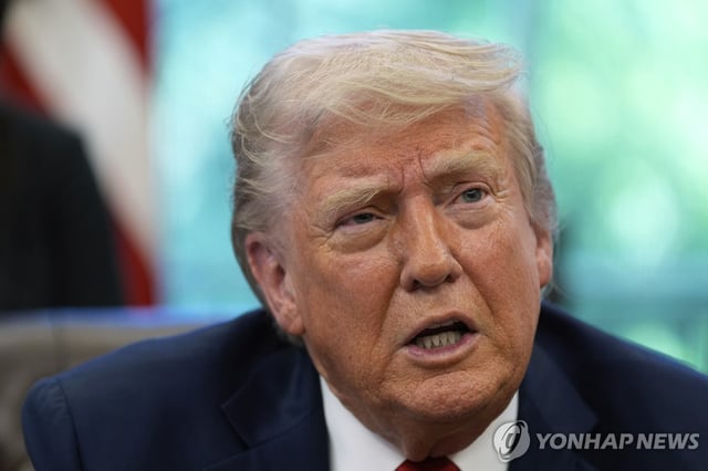 This file photo, released by the Associated Press, shows U.S. President Donald Trump speaking with reporters after signing executive orders in the Oval Office of the White House in Washington on April 23, 2025. (Yonhap)