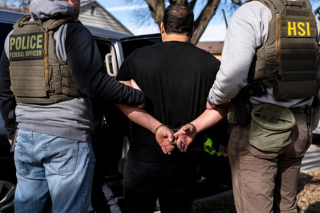 US Immigration and Customs Enforcement agents detain a suspect during a multi-agency targeted enforcement operation in Lyons, Illinois, on January 26.