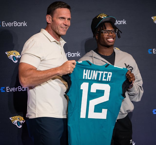 Apr 25, 2025; Jacksonville, FL, USA; Jacksonville Jaguars first round draft pick Travis Hunter poses for a photo with executive vice president of football operations Tony Boselli during a press conference at Miller Electric Center. Mandatory Credit: Travis Register-Imagn Images