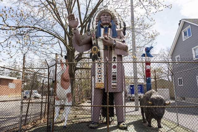 A Big Chief Lewis statue is surrounded by a fence in Massapequa, N.Y., Friday, April 25, 2025. (AP Photo/Julia Demaree Nikhinson)