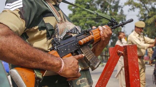 Kathua: A BSF jawan guards as Jammu and Kashmir Police personnel check the vehicles on the Jammu-Srinagar highway after a truck was seized with arms and ammunition, in Kathua, Jammu, Thursday, Sept 12, 2019. (PTI)