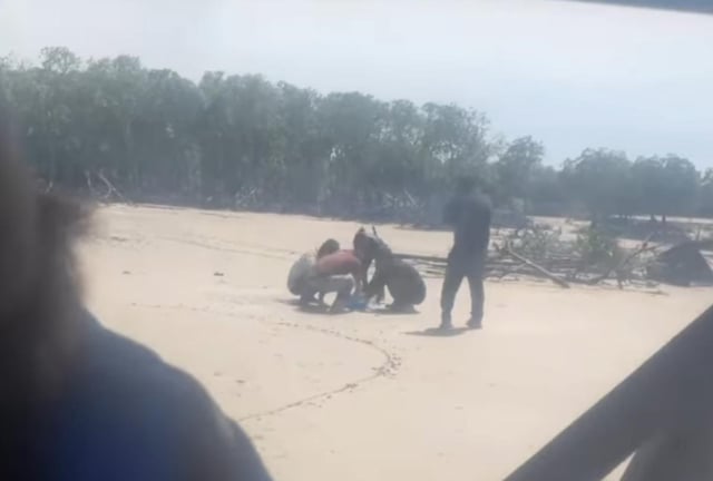 The men on a beach in the Northern Territory.