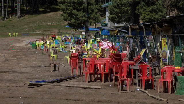 Chairs and tables are scattered at the site of a suspected militant attack on tourists in Baisaran near Pahalgam in south Kashmir's Anantnag district, April 24, 2025. 