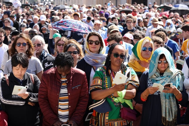 VATICAN CITY, VATICAN - APRIL 26: Members of the faithful gather during the funeral of Pope Francis in St. Peter’s Square on April 26, 2025 in Vatican City, Vatican.