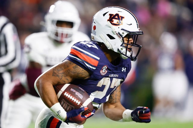 Auburn running back Jarquez Hunter carries the ball against Texas A&amp;M during the first half Nov. 23, 2024, in Auburn, Ala. (AP Photo/Butch Dill)