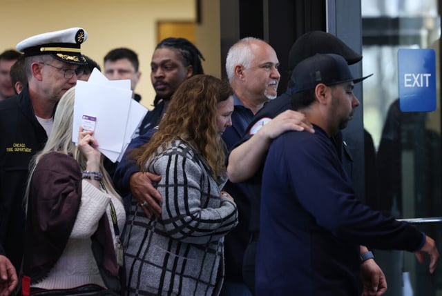 Firefighters escort a relative of Capt. David Meyer after attending the detention hearing for Charles Green, charged with arson and murder, at the Leighton Criminal Court Building on Saturday, April 26, 2025, in Chicago. Meyer died after responding to a fire that Green is charged with starting. (John J. Kim/Chicago Tribune)