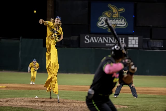 Dakota &#34;Stilts&#34; Albritton #14 of the Savannah Bananas pitches against the Party Animals at Grayson Stadium on May 11, 2023 in Savannah, Georgia. Albritton plays Banana Ball on Stilts. He plays the field, bats, and he pitches all while wearing a pair of stilts while playing. The Historic Grayson Stadium is the home of the independent professional baseball team called the Savannah Bananas. The Bananas were part of the Coastal Plain League, a summer collegiate league, for seven seasons. In 2022, the Bananas announced that they were leaving the Coastal Plain League to play Banana Ball year-round. Banana Ball was born out of the idea of making baseball more fast-paced, entertaining, and fun.