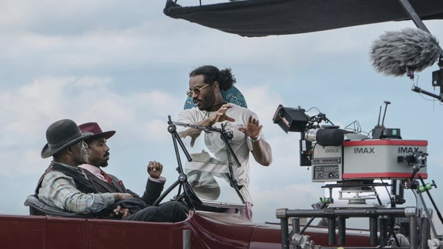 This image released by Warner Bros. Pictures shows actors Delroy Lindo, from left, and Michael B. Jordan with director-writer-producer Ryan Coogler on the set of Sinners. (Eli Adé/Warner Bros. Pictures via AP)