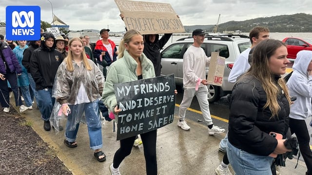 people holding placards in a march to protest violence against women