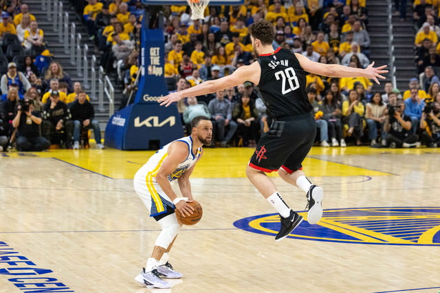 Steph Curry (30) of the Warriors looks to pass as Alperen Sengun (28) of the Rockets leaps up during a game between the Golden State Warriors and the Houston Rockets at Chase Arena on Saturday, April 26, 2025. The game marks the third match of the playoffs.
