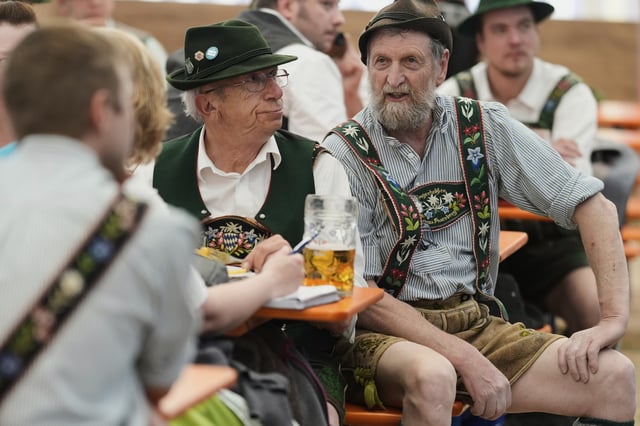 Men dressed in traditional clothes attend the German Championships in Fingerhakeln or finger wrestling, in Pang, near Rosenheim, Germany, Sunday, April 27, 2025. (AP Photo/Matthias Schrader)