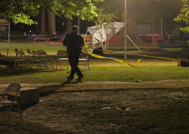 A Pasquotank County Sheriff's Deputy is seen placing crime scene tape around the front of Williams Hall, located in the center of the Elizabeth City State University campus, early Sunday morning.