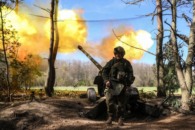 A Russian serviceman of the 30th Motorized Rifle Regiment with the Sever (North) Group of Forces fires a М-46 howitzer towards Ukrainian positions amid Russia's military operation in Ukraine, in Kursk region, Russia.
