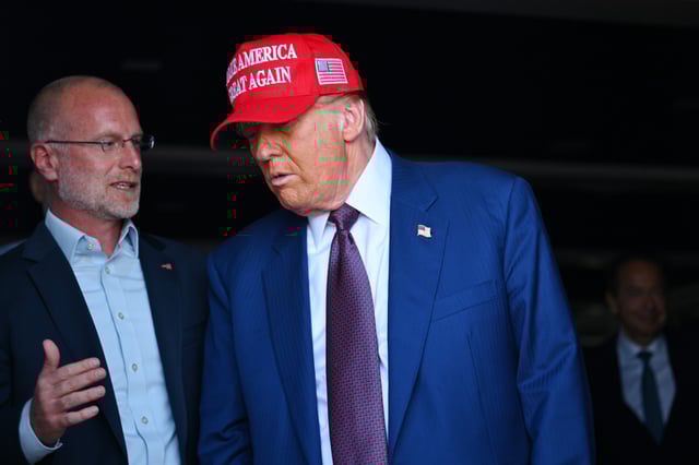 President Donald Trump speaks to Brendan Carr on November 19, 2024, in Brownsville, Texas.