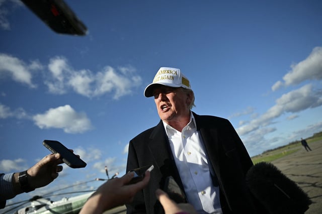 US President Donald Trump speaks to reporters before boarding Air Force One.