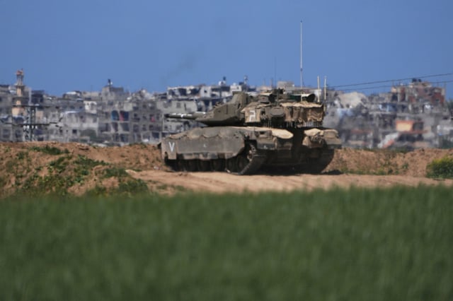 An Israeli tank takes position on the Gaza Strip border in southern Israel, Wednesday, March 19, 2025.