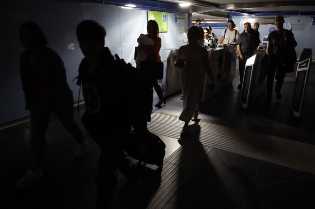 Usuarios del Metro de Madrid abandonan una de las estaciones del suburbano tras registrarse un apagón a nivel peninsular este lunes.