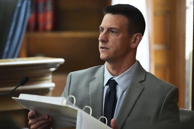 Mass. State Police detective Nicholas Guarino reviews cellular phone logs while testifying during the Karen Read trial at Norfolk Superior Court, Thursday, April 24, 2025, in Dedham, Mass. (AP Photo/Charles Krupa, Pool)