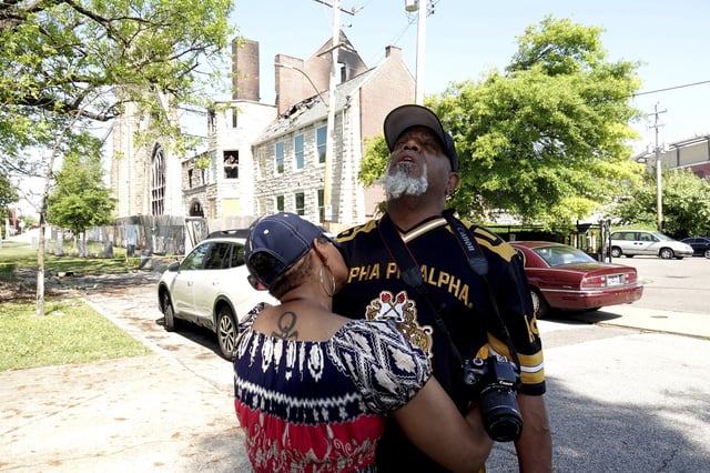 Sadyya Rockett-Miller and her husband Andre LeMoyne Miller grieve outside of the historic Clayborn Temple, a landmark from the civil rights movement with ties to Martin Luther King, that caught fire Monday, April 28, 2025, in Memphis, Tenn. (AP Photo/Karen Pulfer Focht)