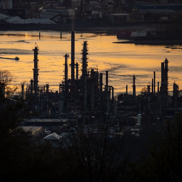 A boat travels past the Parkland Burnaby Refinery on Burrard Inlet at sunset in Burnaby, B.C., on Saturday, April 17, 2021. THE CANADIAN PRESS/Darryl Dyck