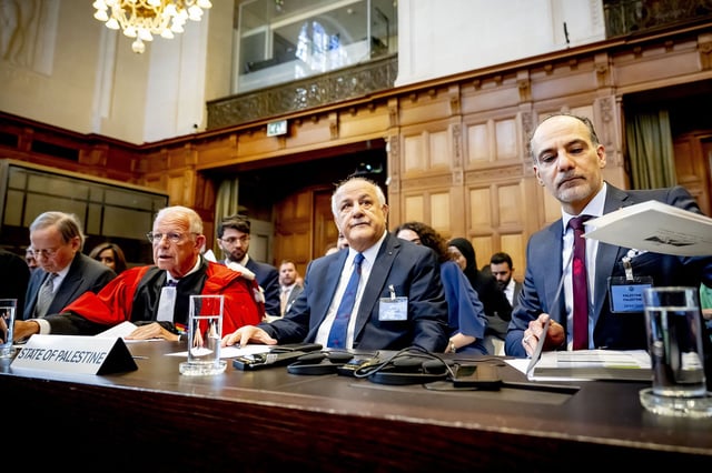 Ammar Hijazi (R), ambassador and permanent representative of the Palestinian Authority to international organizations in the Netherlands, looks on as he attends the ICJ hearing.