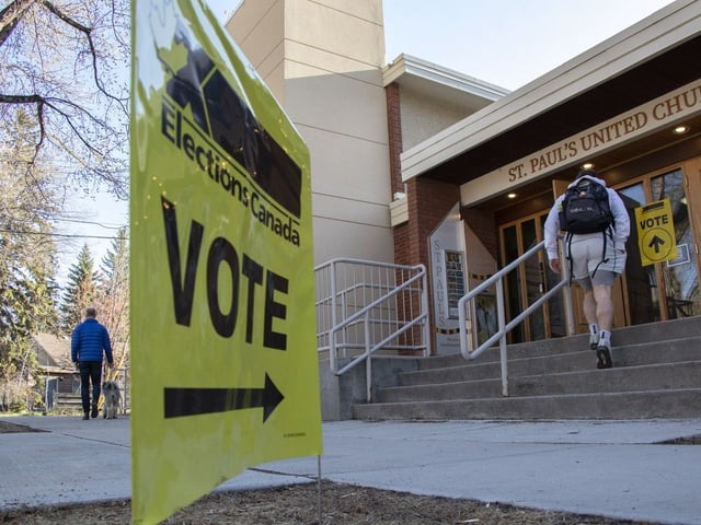 Voters for the federal election stopped to cast their vote at St. Paul's United Church on their way to work, or after walking their kids to the nearby school in Edmonton on Monday, April 28, 2025.