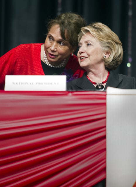 FILE - Former Secretary of State Hillary Rodham Clinton talks with former Labor Secretary Alexis Herman prior to addressing the 51st Delta Sigma Theta National Convention in Washington, July 16, 2013. (AP Photo/Cliff Owen, file)