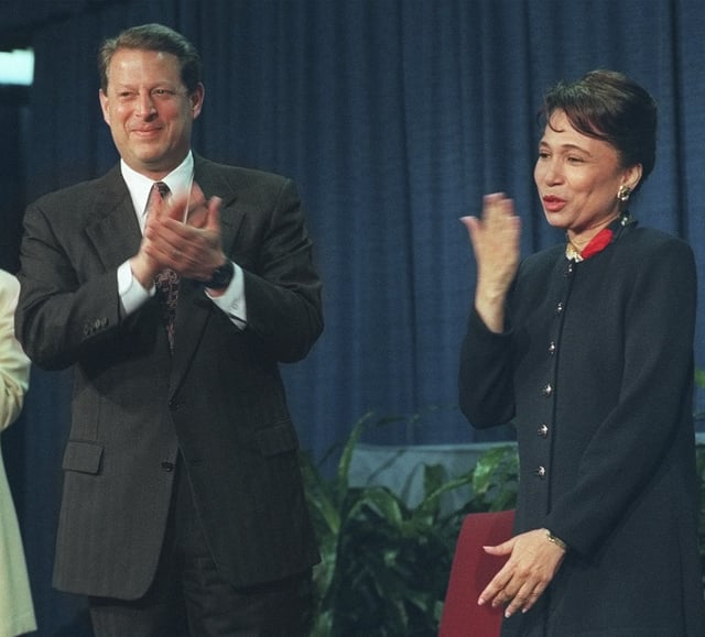 FILE - Vice President Gore applauds Alexis Herman while Herman blows a kiss to the audience after a reenactment of her swearing in as Secretary of Labor, May 9, 1997, in Washington. (AP Photo/Reggie Pearman, file)