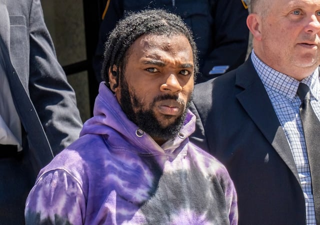 Marvin DanKwah accused of shooting an off-duty NYPD Officer in his leg during what was reportedly an attempted carjacking, is seen here being taken from the NYPD 109th Precinct in Queens on Monday April 28, 2025.  (Theodore Parisienne / New York Daily News)