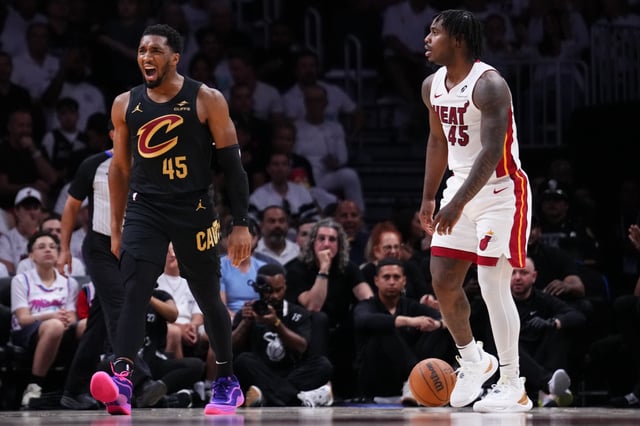 Donovan Mitchell #45 of the Cleveland Cavaliers reacts after forcing a foul against Davion Mitchell #45 of the Miami Heat during the second quarter in Game Three of the Eastern Conference First Round NBA Playoffs at Kaseya Center on April 26, 2025 in Miami, Florida.