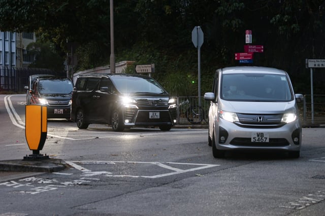 Vans believed to be carrying former Hong Kong lawmakers Kwok Ka-ki and Jeremy Tam leave from Stanley Prison, after serving four-year and two months sentences for conspiracy to commit subversion in a landmark national security case, in Hong Kong, China, April 29, 2025. REUTERS/Tyrone Siu