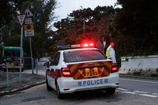 A police officer stands guard outside Stanley Prison during the release of former lawmakers Kwok Ka-ki and Jeremy Tam, convicted in a landmark national security case, in Hong Kong, China, April 29, 2025. REUTERS/Tyrone Siu