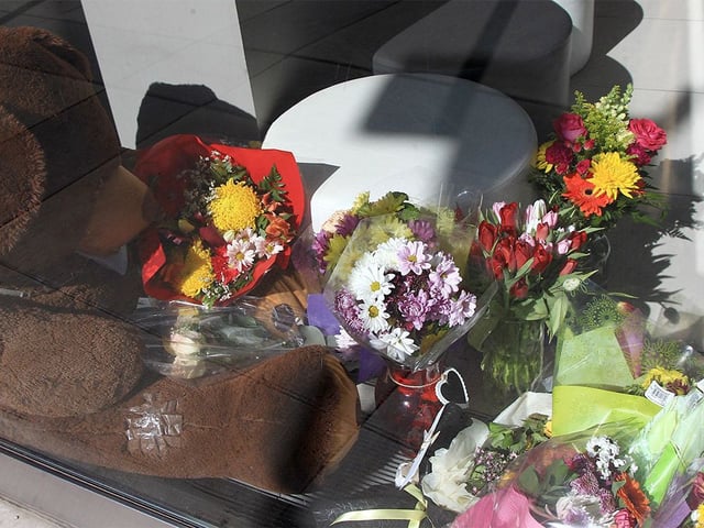 A makeshift memorial of flowers and letters for stabbing victim Vanessa Ladouceur is seen inside a private commercial building near the site of the attack last Friday along 10th Ave S.E. on March 22, 2022.