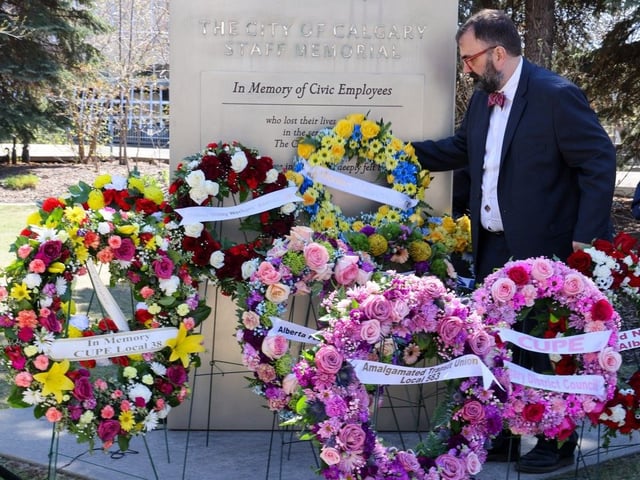 Calgary and District Labour Council president Alex Shevalier lays a wreath during the National Day of Mourning , Monday April 28, 2025. The National Day of Mourning is dedicated to remembering those who have lost their lives, suffered injury or illness on the job, or experienced a work-related tragedy.