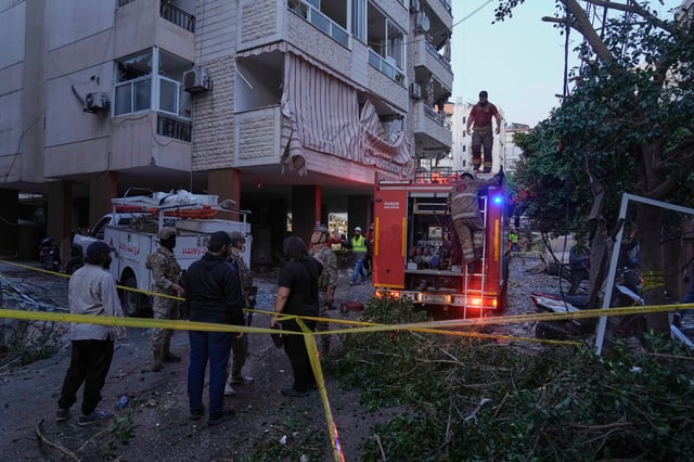 Civil defence workers and Lebanese soldiers gather at the site of an Israeli airstrike in Dahiyeh in the southern suburb of Beirut, Lebanon, Sunday, April 27, 2025. (AP Photo/Bilal Hussein)