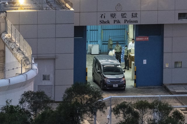 Vehicles believed to be carrying former pro-democracy lawmaker Gary Fan, who was released after four years for his conviction under the national security law, leaves the Shek Pik Prison in Hong Kong, Tuesday, April 29, 2025. (AP Photo/Chan Long Hei)