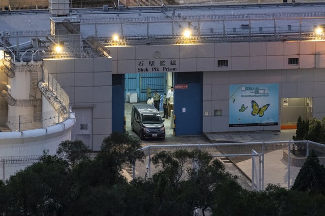 Vehicles believed to be carrying former pro-democracy lawmaker Gary Fan, who was released after four years for his conviction under the national security law, leaves the Shek Pik Prison in Hong Kong, Tuesday, April 29, 2025. (AP Photo/Chan Long Hei)