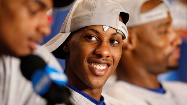 Kansas Jayhawks guard Mario Chalmers (15) smiles as he listens to teammates at a press conference after the 2008 NCAA Championship game against the Memphis Tigers at the Alamodome on April 7, 2008.