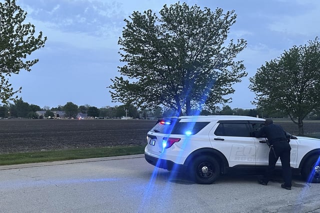 Police block a road leading to a building where a car smashed through during an after-school program, killing several people and injuring others, Monday, April 28, 2025, in Chatham, Ill. (AP Photo/John O'Connor)