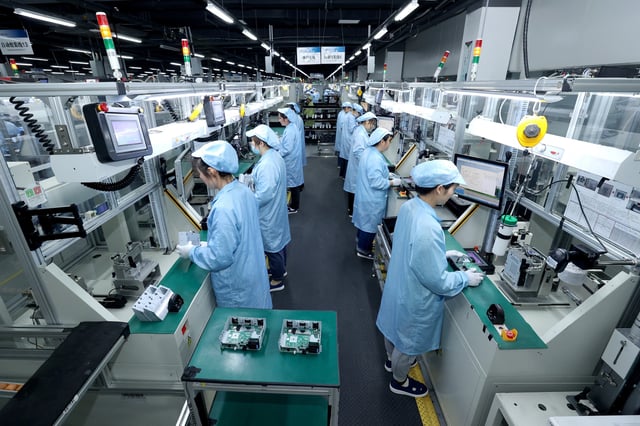 Workers work on a production line at a factory in Suqian, Jiangsu Province, China April 9, 2025. China Daily via REUTERS/File Photo