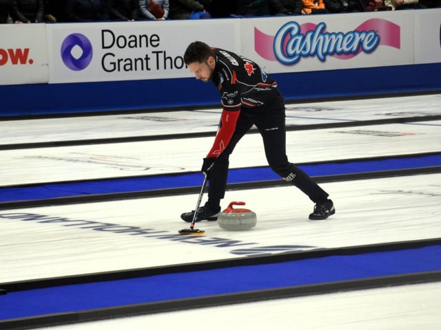 Brett Gallant of Charlottetown sweeps a rock during the 2025 Canadian mixed doubles curling championship in Summerside, P.E.I., in March. Gallant and his wife, Jocelyn Peterman, are competing for Canada at the 2025 world mixed doubles curling championship at Willie O'Ree Place in Fredericton this week.