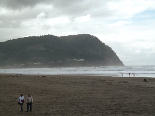 People stroll on the misty beach of Seaside, Oregon, on March 19, 2011.
