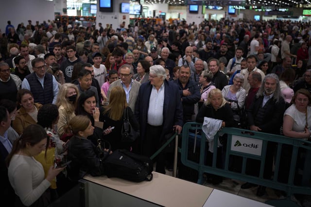 Passengers crowd the train accesses at Sants train station in Barcelona, Spain, on Tuesday.